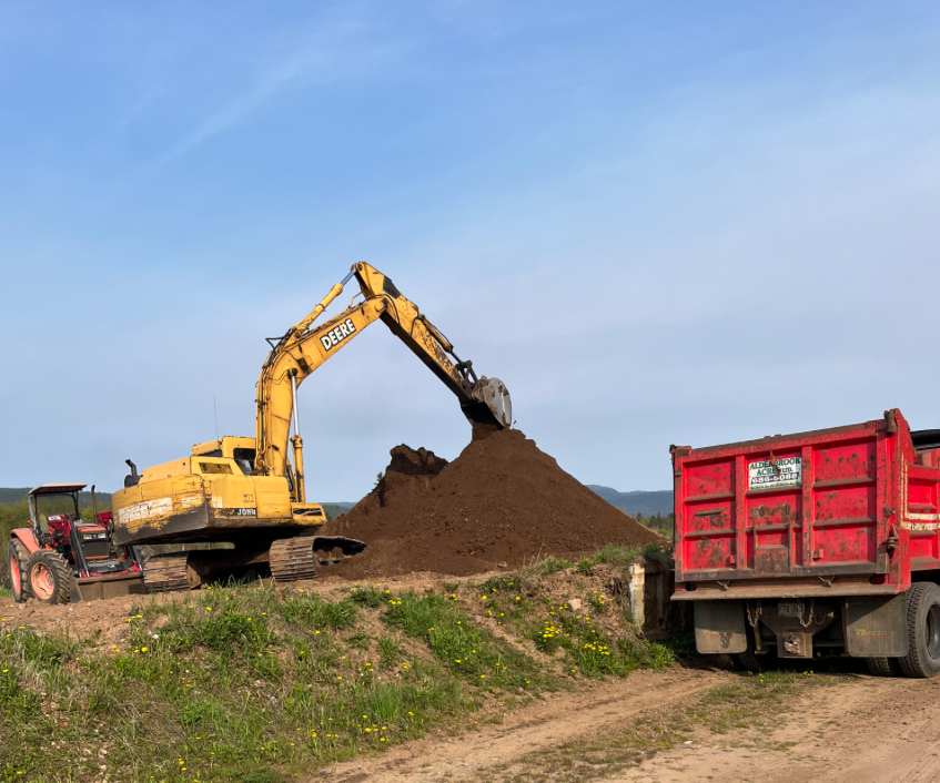 Excavator with topsoil